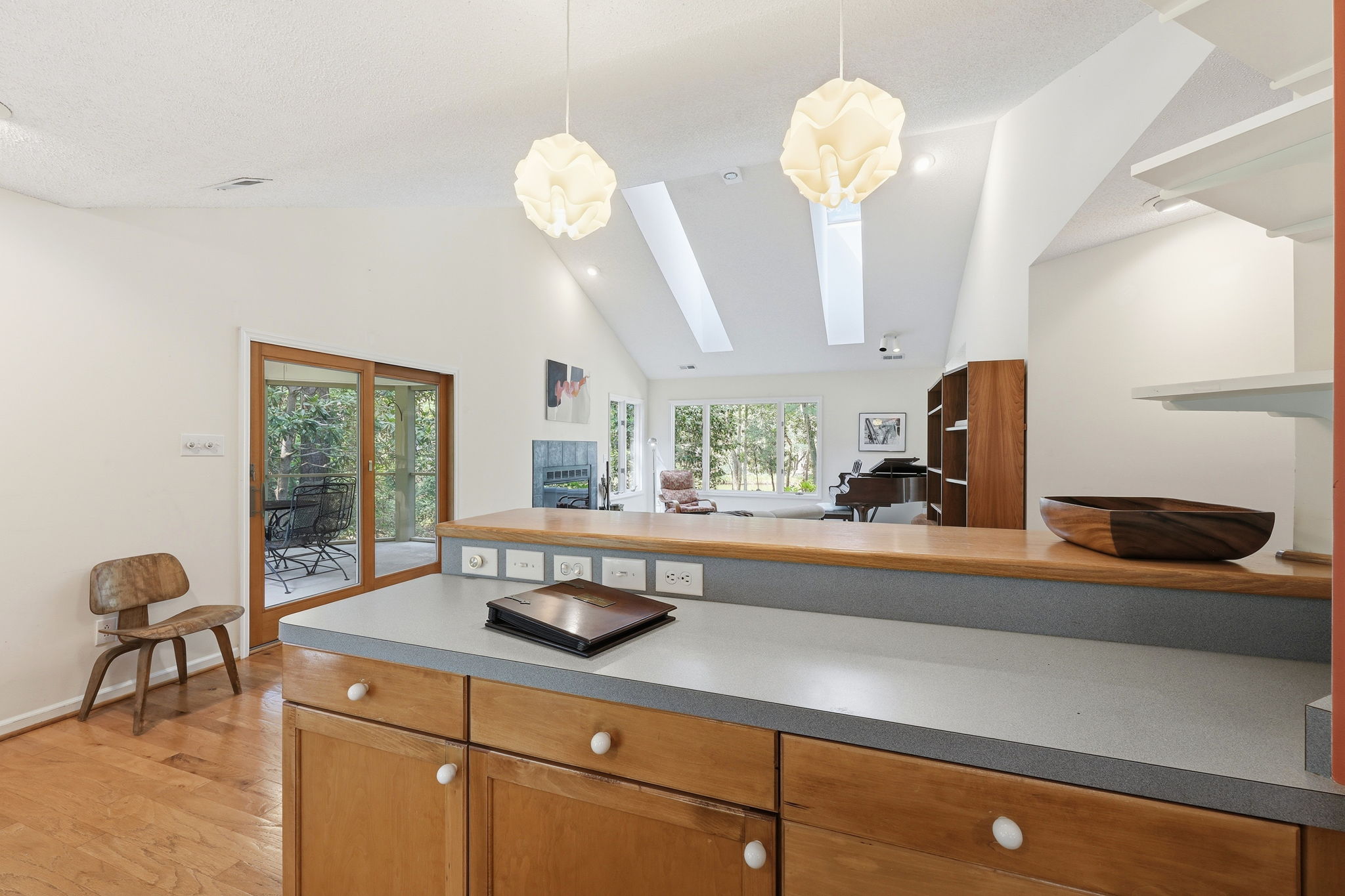 Open kitchen with vaulted ceiling and skylights