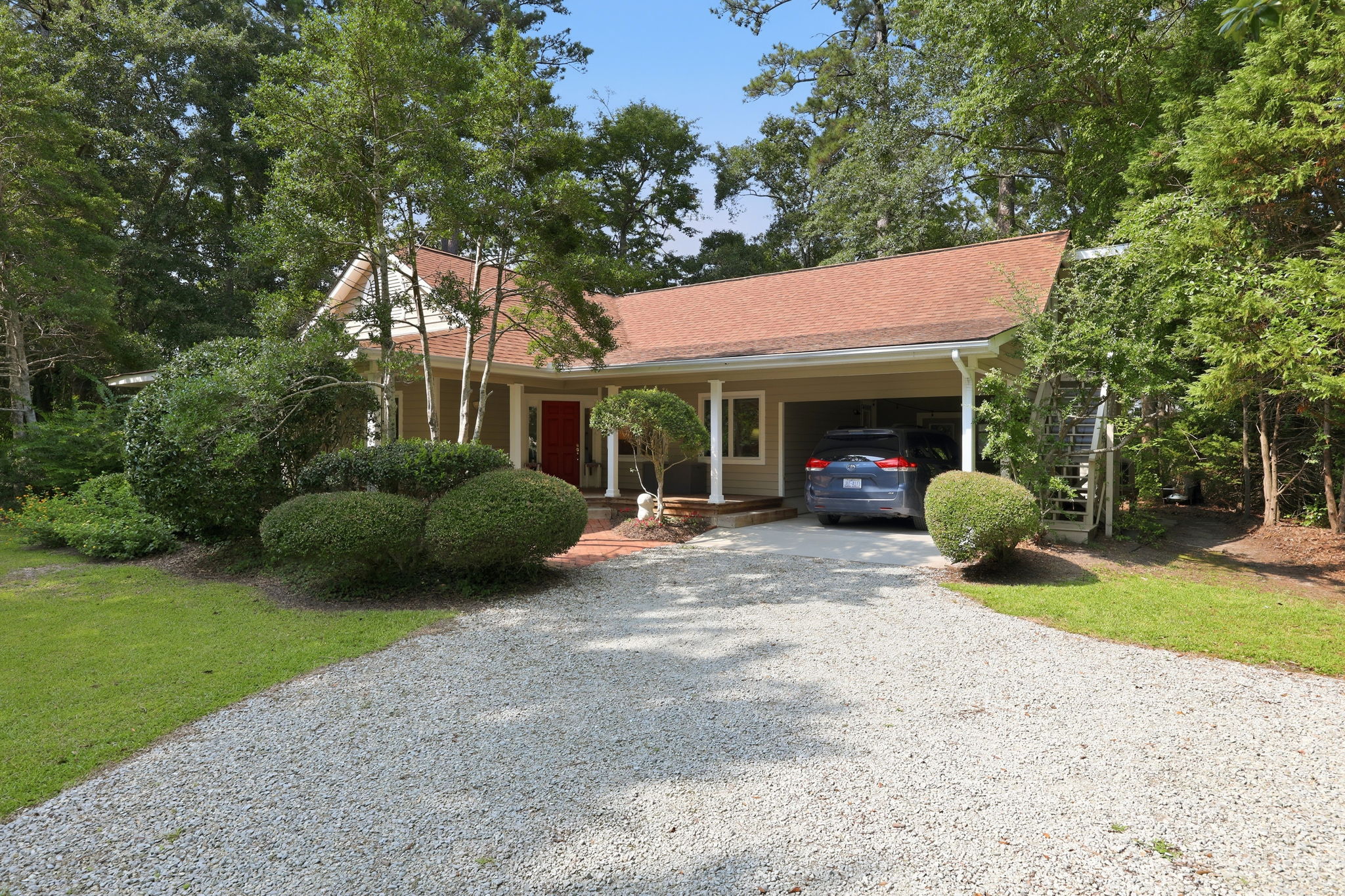 Front approach with circular drive and carport